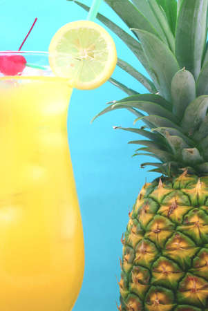 Pineapple and Drink on Blue Backgroundの写真素材