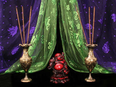 Buddha and  Incense on Black Background With Purple and Green Scarvesの写真素材