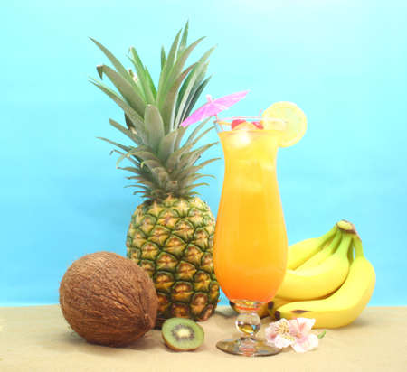 Fruit and Tropical Drink on Sand With Blue Backgroundの写真素材