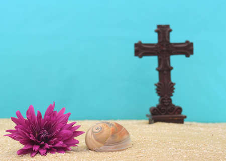 Shell and Flower on Sand With Cross, Shallow DOF, Focus on Shellの写真素材