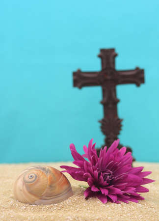 Shell and Flower on Sand With Cross, Shallow DOF, Focus on Shellの写真素材