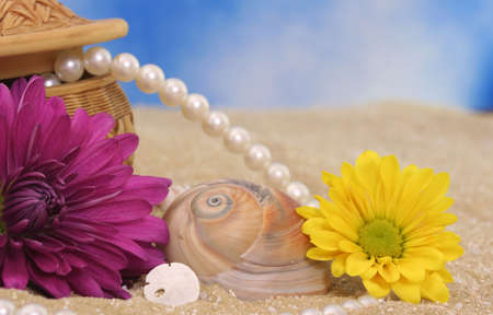 Sea Shells and Flowers with Pearls on Beachの写真素材