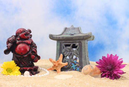 Still Life With Buddha, Flowers and Sea Shells on Beachの写真素材
