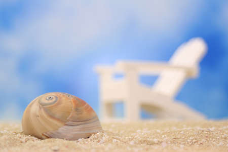 Sea Shell on Sand With Chair in Background, Shallow DOFの写真素材