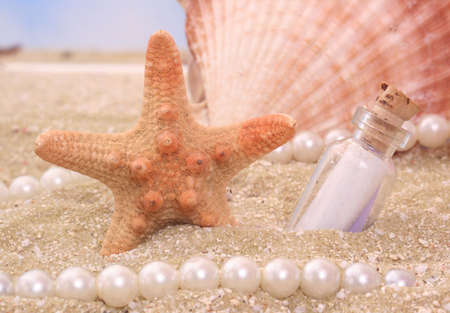 Starfish With Bottle on Sand With Pearls and Shellの写真素材