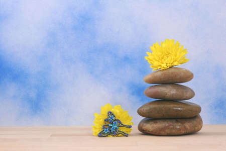 Balanced Massage Stones on Blue Textured Backgroundの写真素材