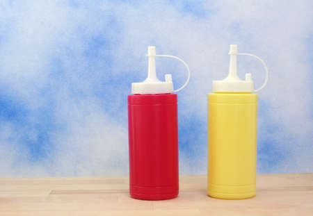 Ketchup and Mustard on Blue Textured Backgroundの写真素材