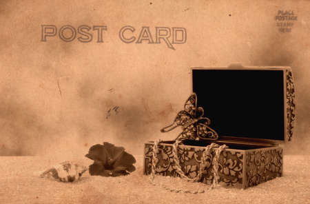 Vintage Style Postcard With Jewelry Box on Sandの写真素材