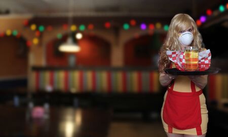 Waitress With N95 Mask and Tray of Food in Restaurant, Shallow DOF Focus on Trayの写真素材