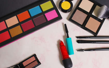 Cosmetics on pink marbled paper backgroundの写真素材