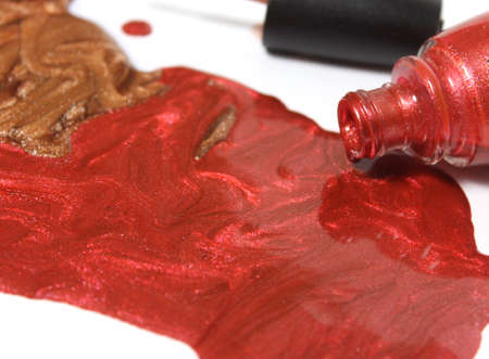 Gold and Copper Metallic Nail polish on White Backgroundの写真素材