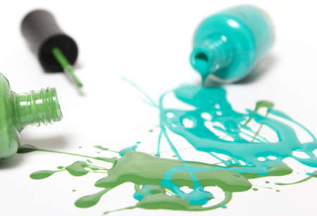 Blue and Green Spilled Nail Polish on White Backgroundの写真素材