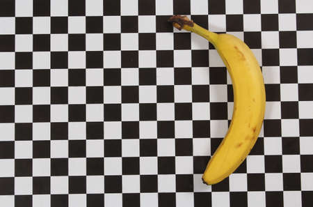Ripe Banana on Black and White Checkered Table