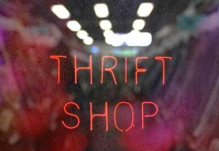 Vintage Neon Thrift Shop Sign in Wet Windowの写真素材
