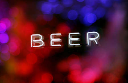 Neon Beer Sign With Colorful Bokehの写真素材
