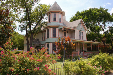 Victorian House with fence and plantsの写真素材