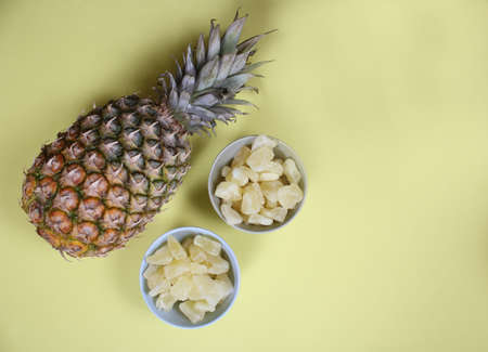 Fresh and Dried Organic Pineapple on yellow Background Closeupの写真素材