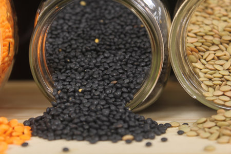 Black, Green and Orange Lentils on Wooden Tableの写真素材