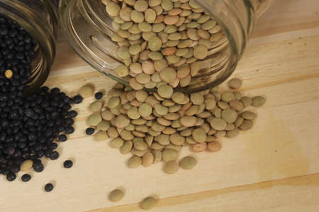 Black, Green and Orange Lentils on Wooden Table