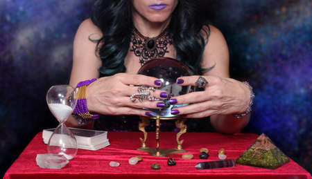 Psychic with Crystal Ball. and tarot cards on Galaxy Backgroundの写真素材