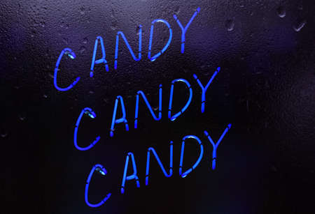Candy Candy Candy Neon Sign in Rainy Window Candy Shop Windowの写真素材