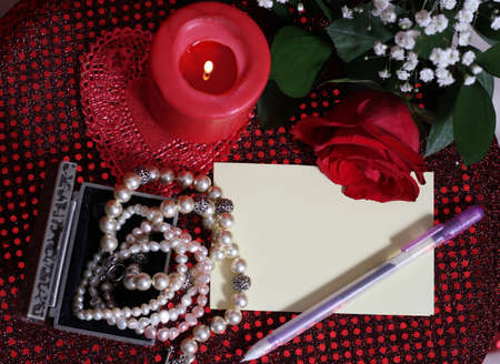 Rose and Candle With Pearls on Red Backgroundの写真素材