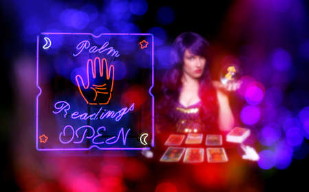 Tarot Card Readings Neon Sign in Window with Psychic Tarot Card Reader blurred in backgroundの写真素材