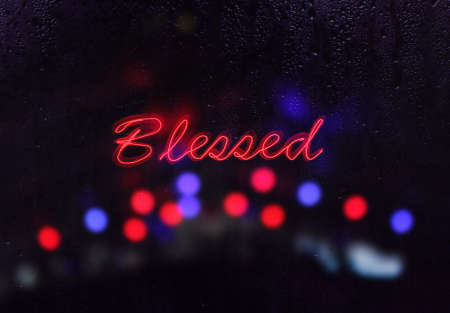 Vintage Neon Blessed Sign in Rainy Windowの写真素材
