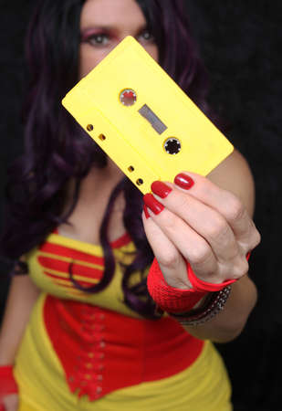 Yellow Cassette Tape With Woman in Retro clothing Shallow DOFの写真素材