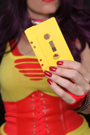 Yellow Cassette Tape With Woman in Retro clothing Shallow DOFの写真素材