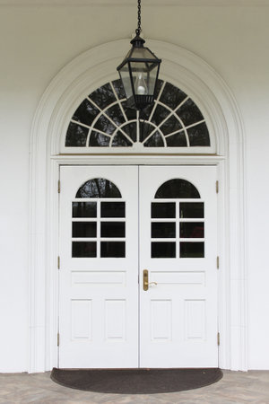 Close up of Church Doors on Small White Church With Lanternの写真素材
