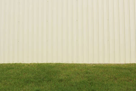 Lawn With Green Grass and Metal Building Close up