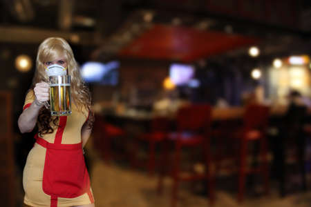 Waitress With N95 Mask Holding Beer Mug, Shallow DOF Focus on Beerの写真素材