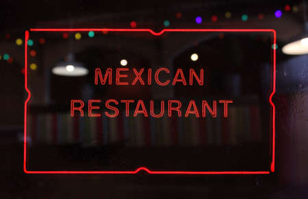 Vintage Neon Mexican Restaurant Sign in Rainy Windowの写真素材