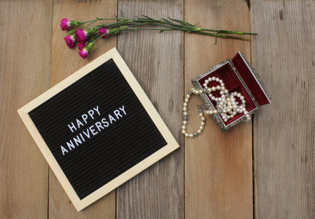 Happy Anniversary Sign With Pearls in Jewelry Box and Flower
