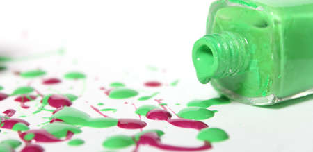 Pink and Green Spilled Nail Polish on Whiteの写真素材