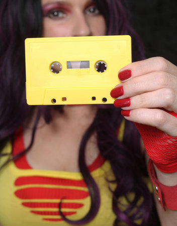 Yellow Cassette Tape With Woman in Retro clothing Shallow DOFの写真素材