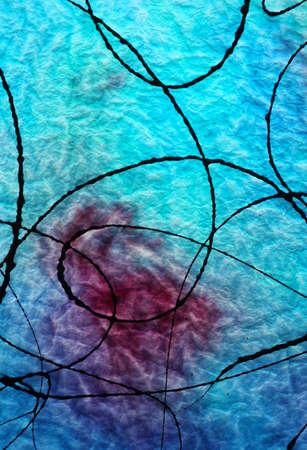 Antique Blue Glass With Black Paint Splashed on surface and Light Shining through back of glass