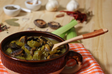 Hearty Mushroom and Celery Soup With Spicy Vegetable Broth in Rustic Kitchenの写真素材