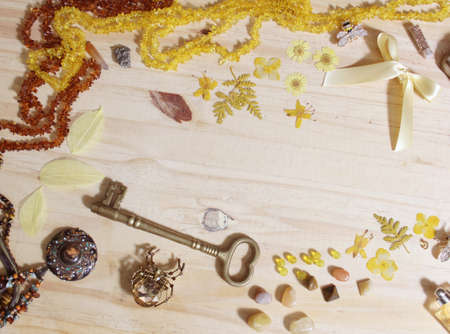 Yellow and Brown Jewelry and Decorations with Vintage Brass Key on Wooden Tableの写真素材