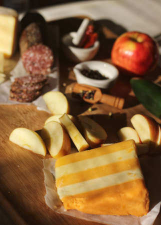Peppercprn Salami With Five Layered English Shire Cheese in Rustic Kitchen With Natural Lightの写真素材