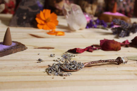 Dried Lavender and Rose Petals on Table With Incense Cones and Rock Crystalsの写真素材