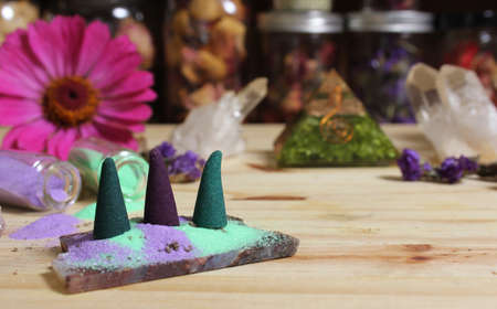 Incense Cones on Stone Slab With Chakra Crystals and Flowersの写真素材