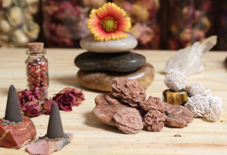 Incense Cones and Desert Rose Rocks on Meditation Table With Pyramid in Backgroundの写真素材