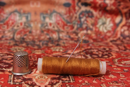 Thread With Thimble on Colorful Vintage Fabric