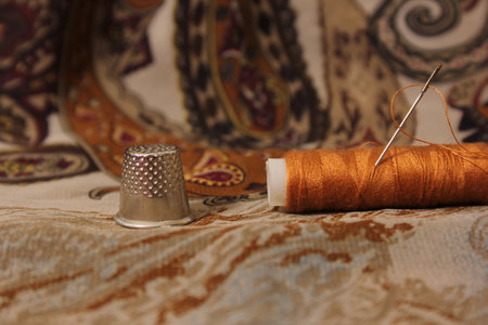 Thread With Thimble and Scissors on Vintage Fabricの写真素材