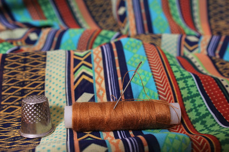 Thread With Thimble on Colorful Vintage Fabric