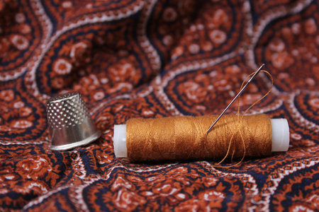 Thread With Thimble on Colorful Vintage Fabric