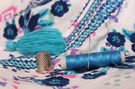 Vintage Embroidered Fabric With Spool of Blue Thread