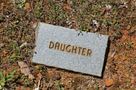 Granite Brick Stone in Cemetery With Word Daughter Engravedの写真素材